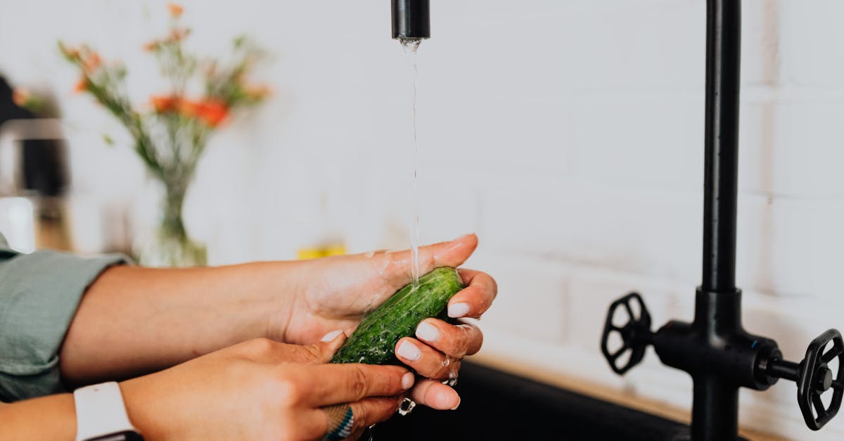 A woman carefully washing fresh vegetables and fruits under running water at a clean kitchen sink, bright natural light, food safety and hygiene concept, realistic photography