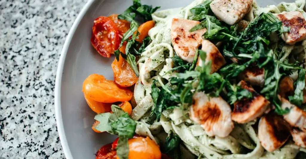 Close-up of a balanced meal with grilled lean beef, sautéed spinach with lemon wedge, and a side of lentils in a white bowl on a rustic wooden table, natural light, iron-rich diet concept, realistic food photography