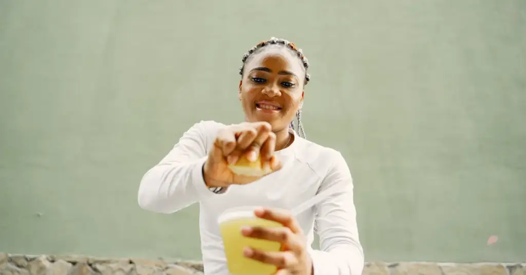 A woman squeezing fresh lemon juice over a colorful salad with chickpeas, red peppers and dark leafy greens in a bright kitchen, healthy eating habits, vitamin C and iron absorption concept, realistic photography