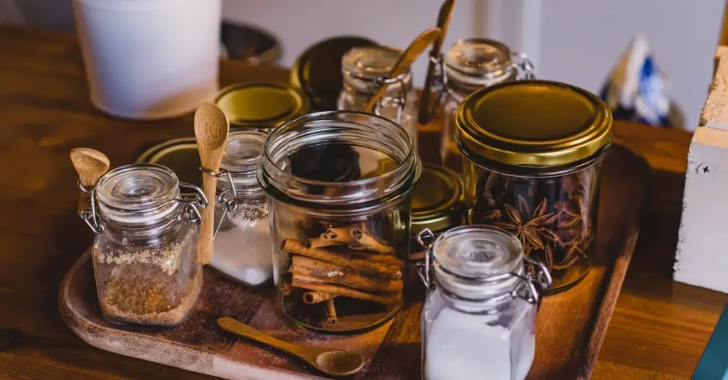 Close-up of multiple glass jars with different dried herbal teas labeled in Portuguese, next to a warning label and medication pills, concept of interactions between herbs and medicine, clean studio lighting, realistic photography